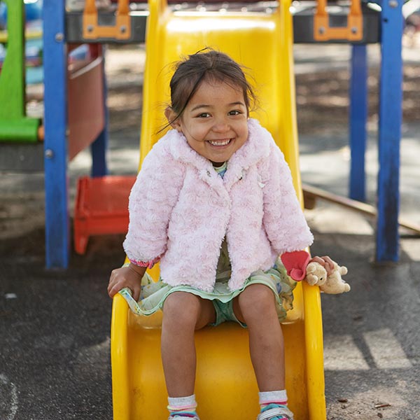 child on slippery slide