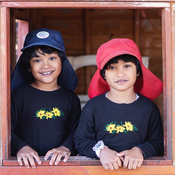 two children sitting on a box